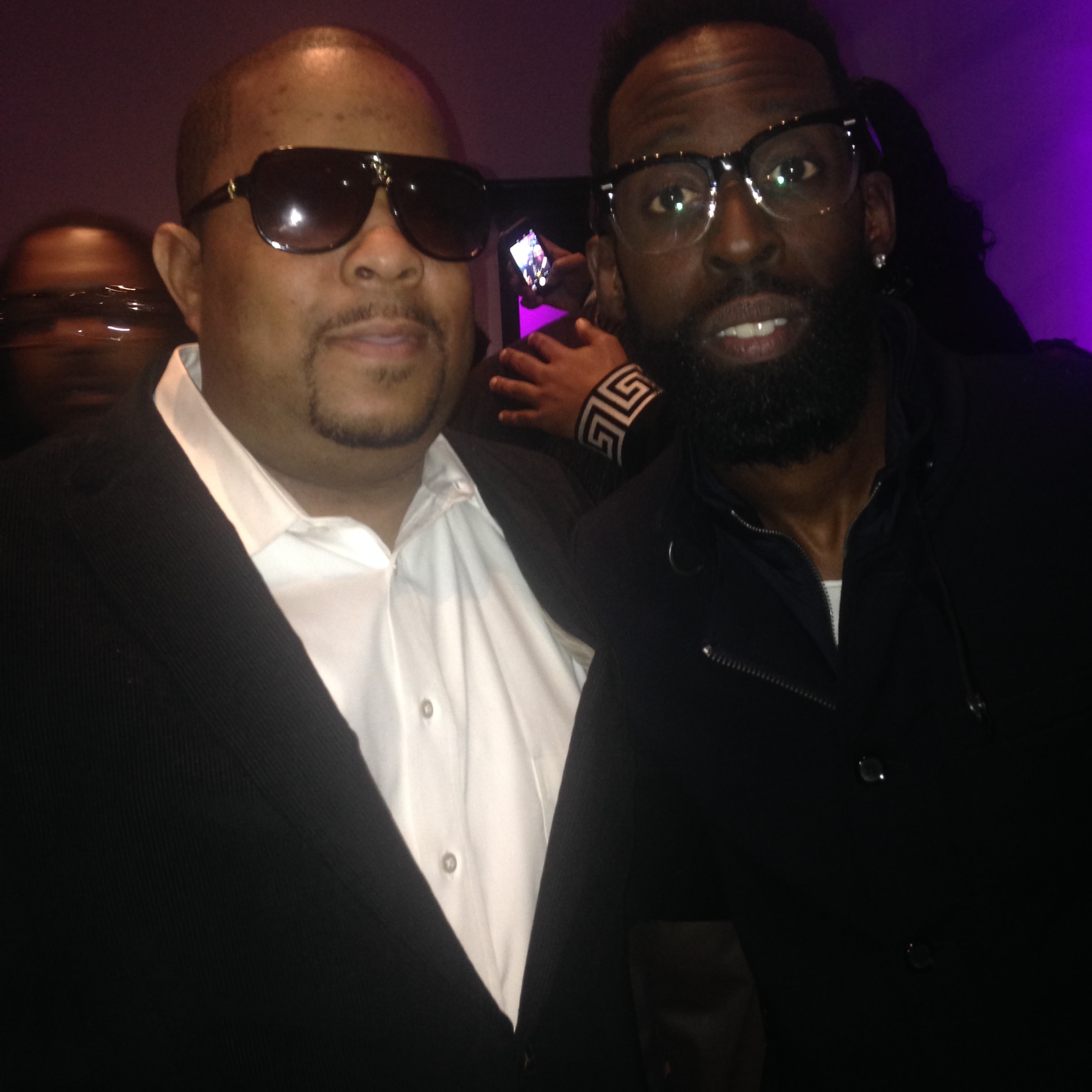 Two men at an event with purple ambient lighting