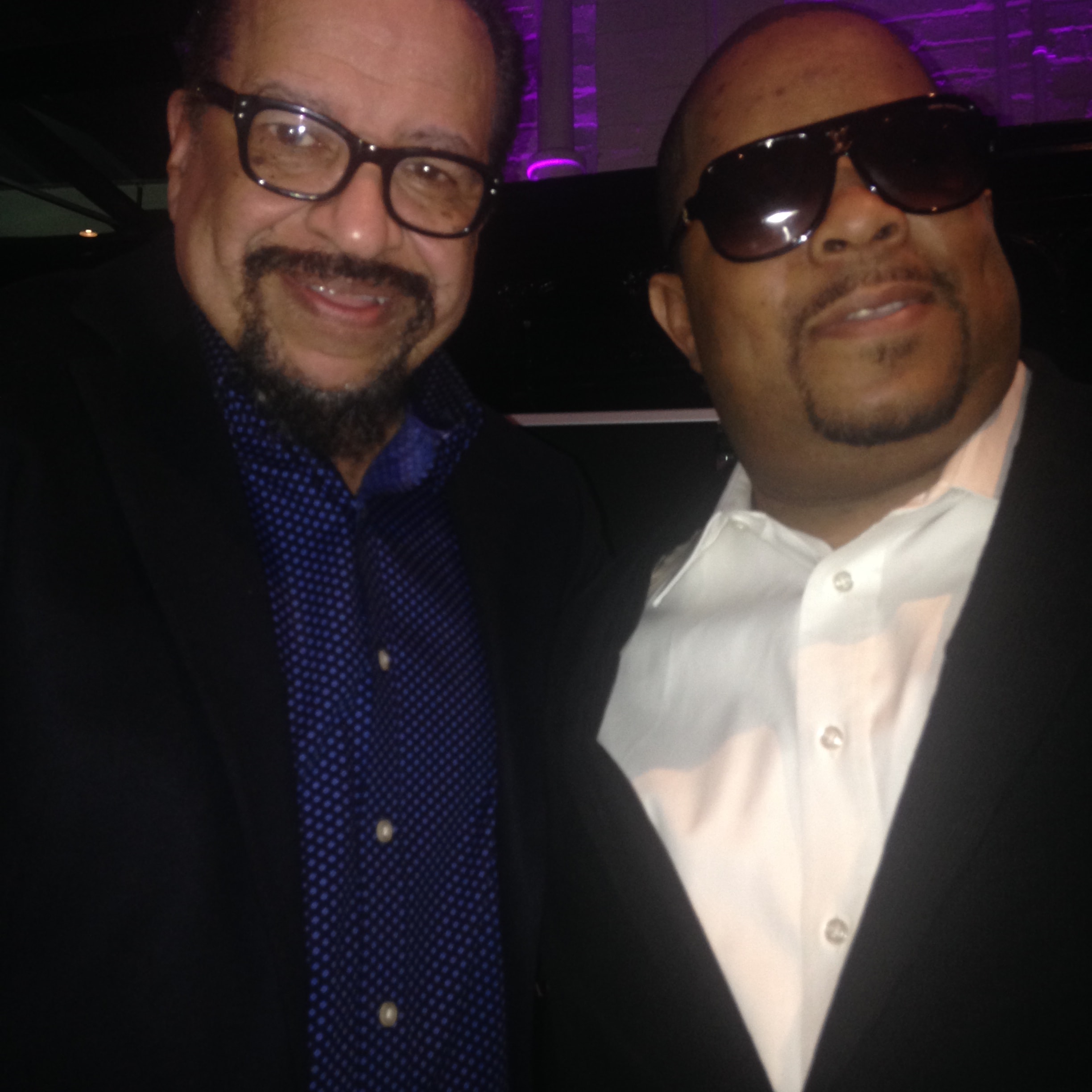 Two men smiling together at an event