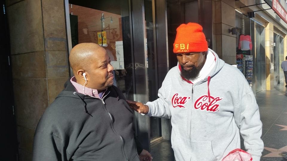 Two men in conversation on the street