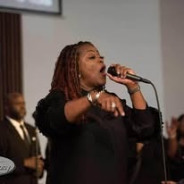Vocalist performing at worship service with microphone