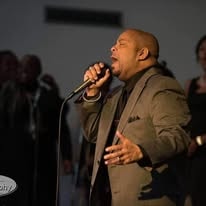 John Tillery singing passionately on stage