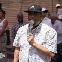 John Tillery speaking at outdoor microphone