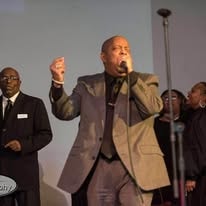 John Tillery singing passionately on stage at worship concert