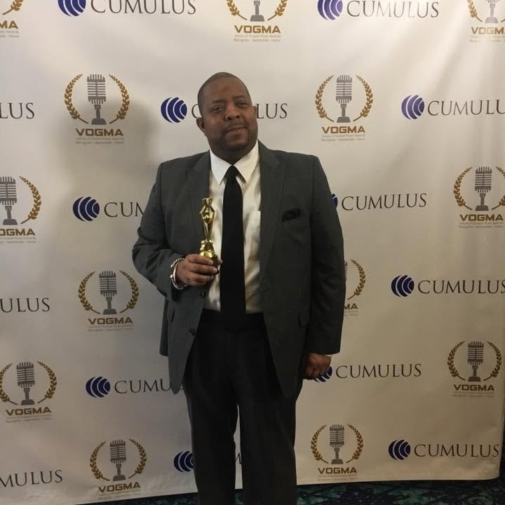 John Tillery at the VOGMA awards holding a trophy