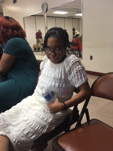 Young girl in white dress at ministry event
