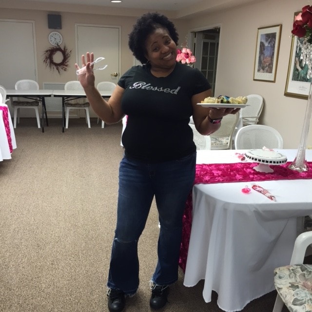 Woman in Blessed t-shirt holding a plate at a ministry gathering