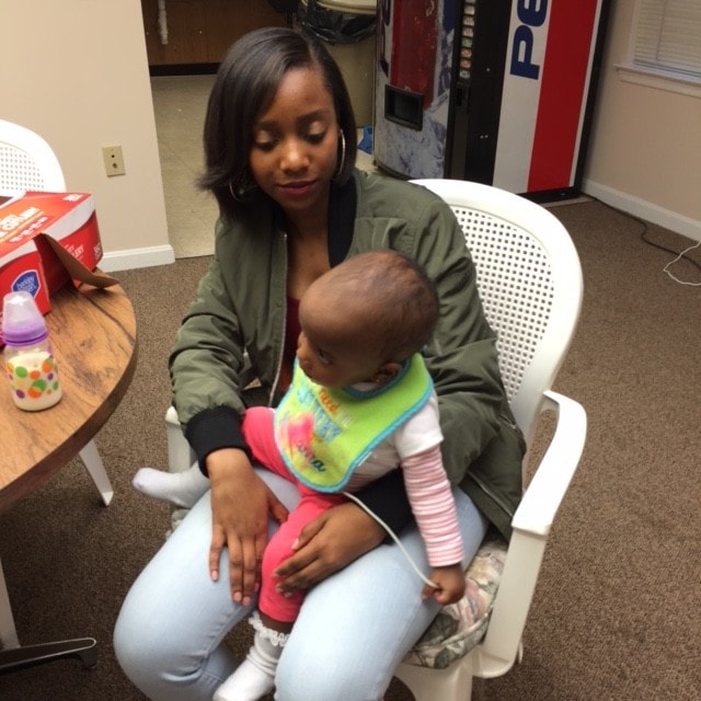 Woman holding a baby at a ministry gathering