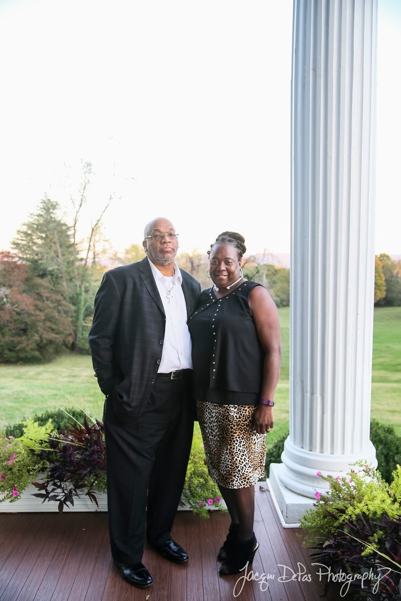 Couple posing on a porch at a formal outdoor event