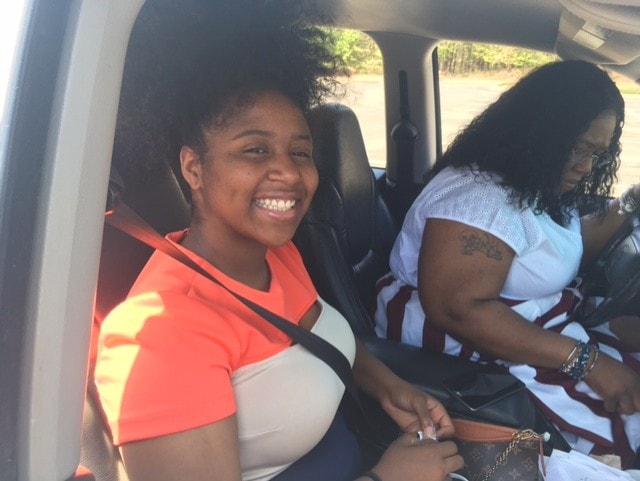 Two women smiling in a vehicle — candid road trip moment