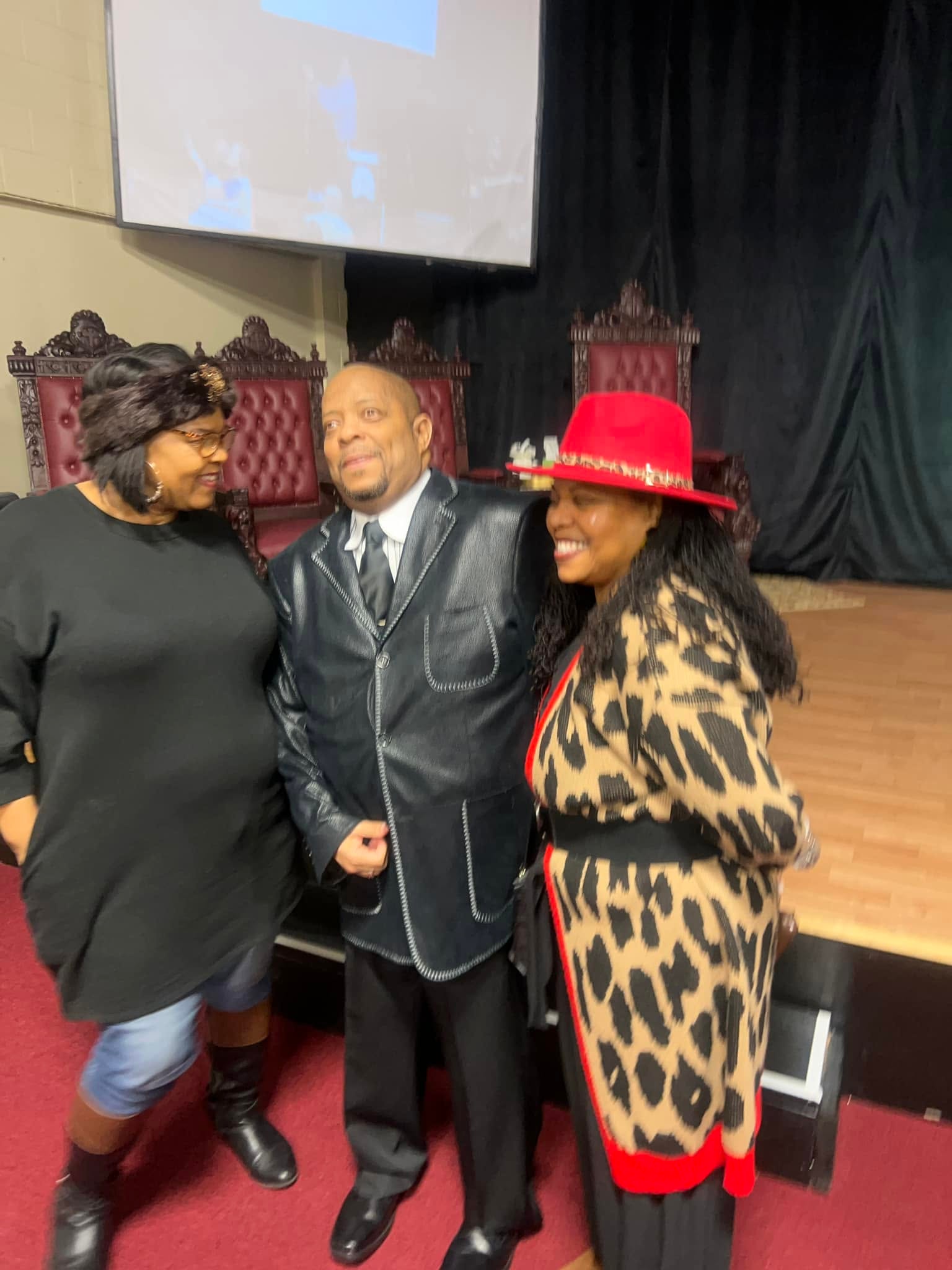 Pastor Tillery with two ladies at church ministry event
