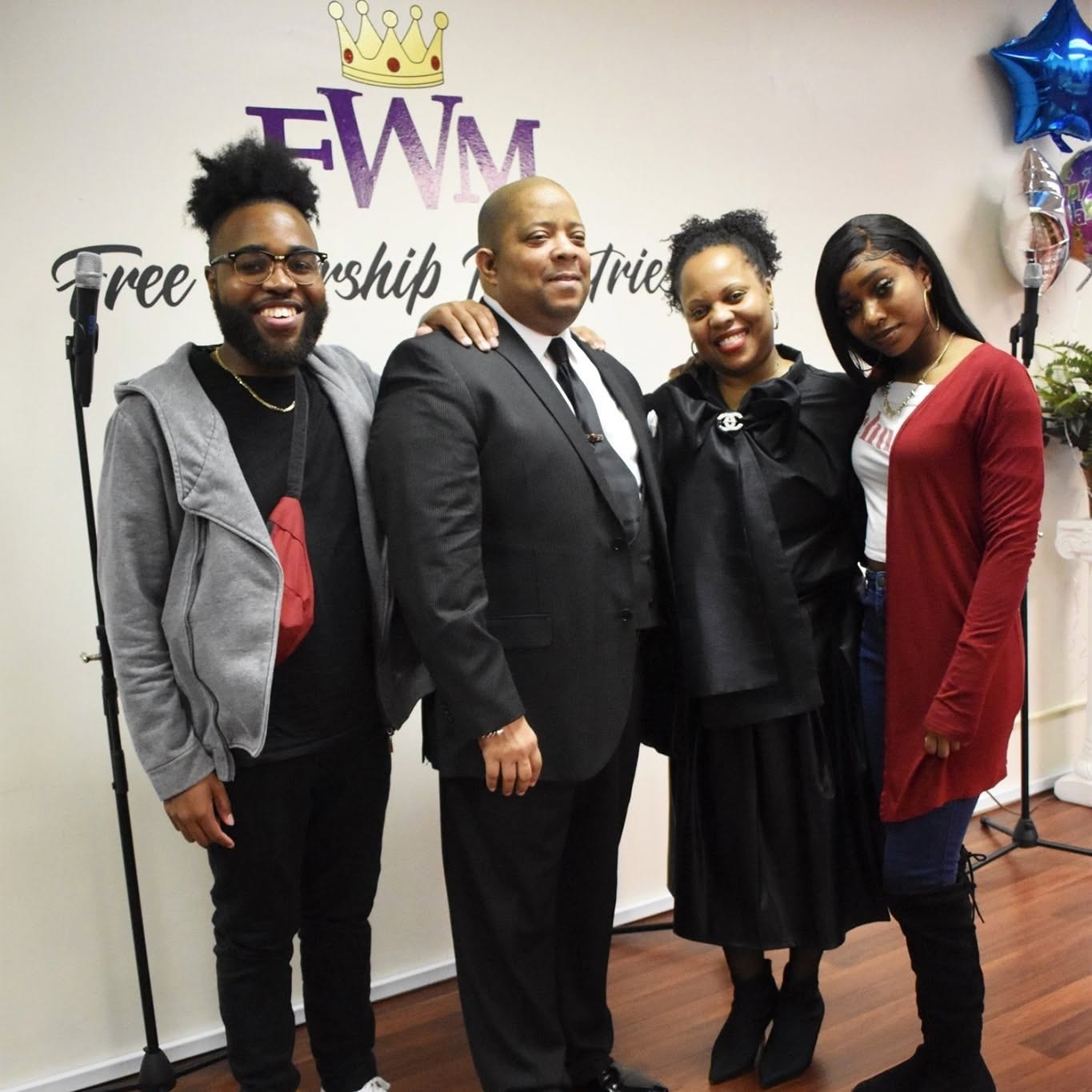 Group photo at Free Worship Ministries with FWM backdrop